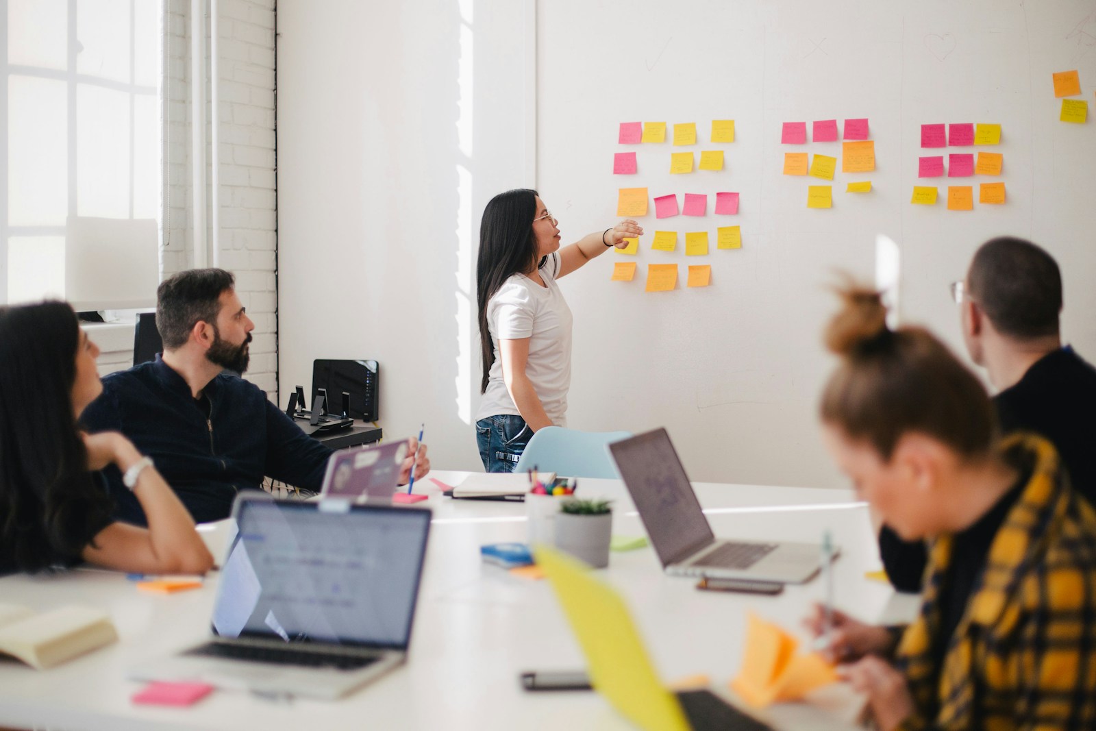 Brand workshop around a long table with printed boards and notes